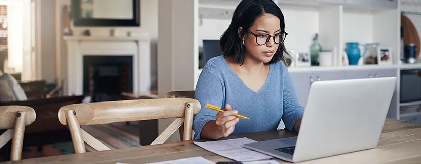 A marketing and digital professional working from home on her laptop